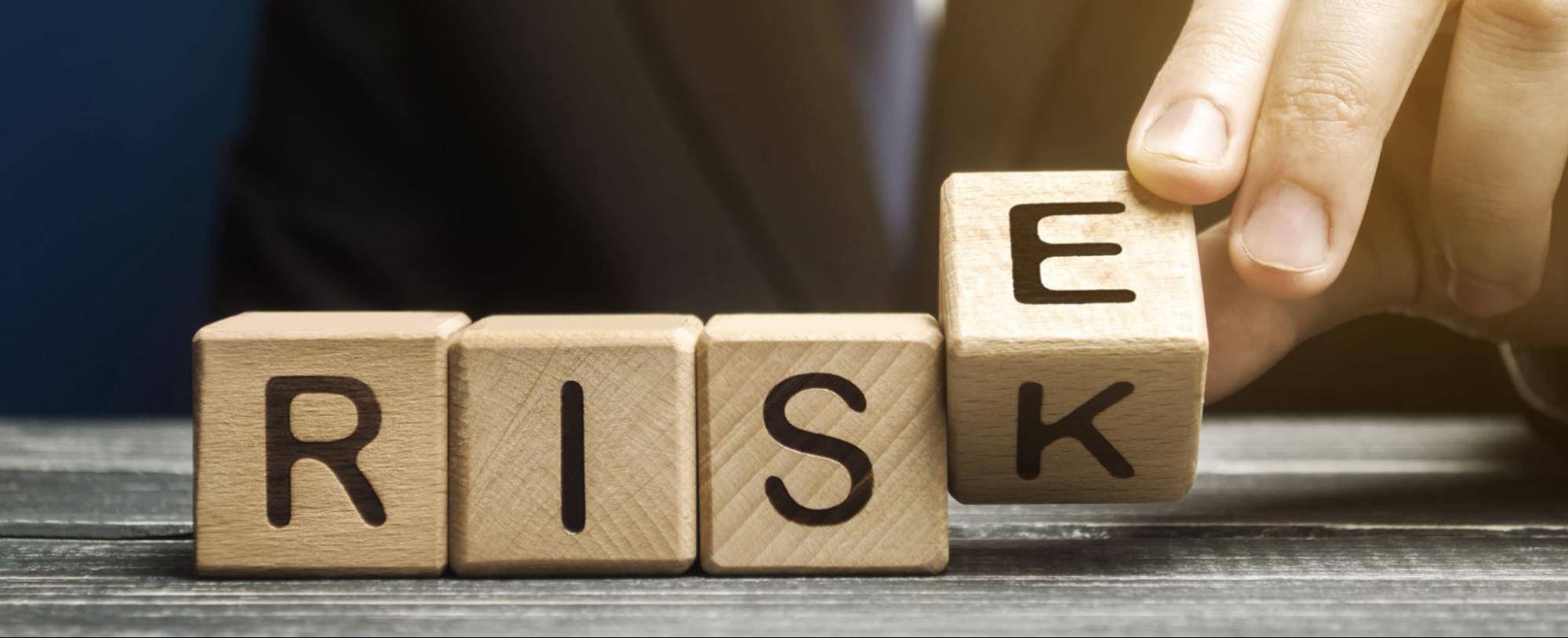 A hand transforms the word ‘risk’ into ‘rise,’ representing how smart coverage helps businesses strengthen their future