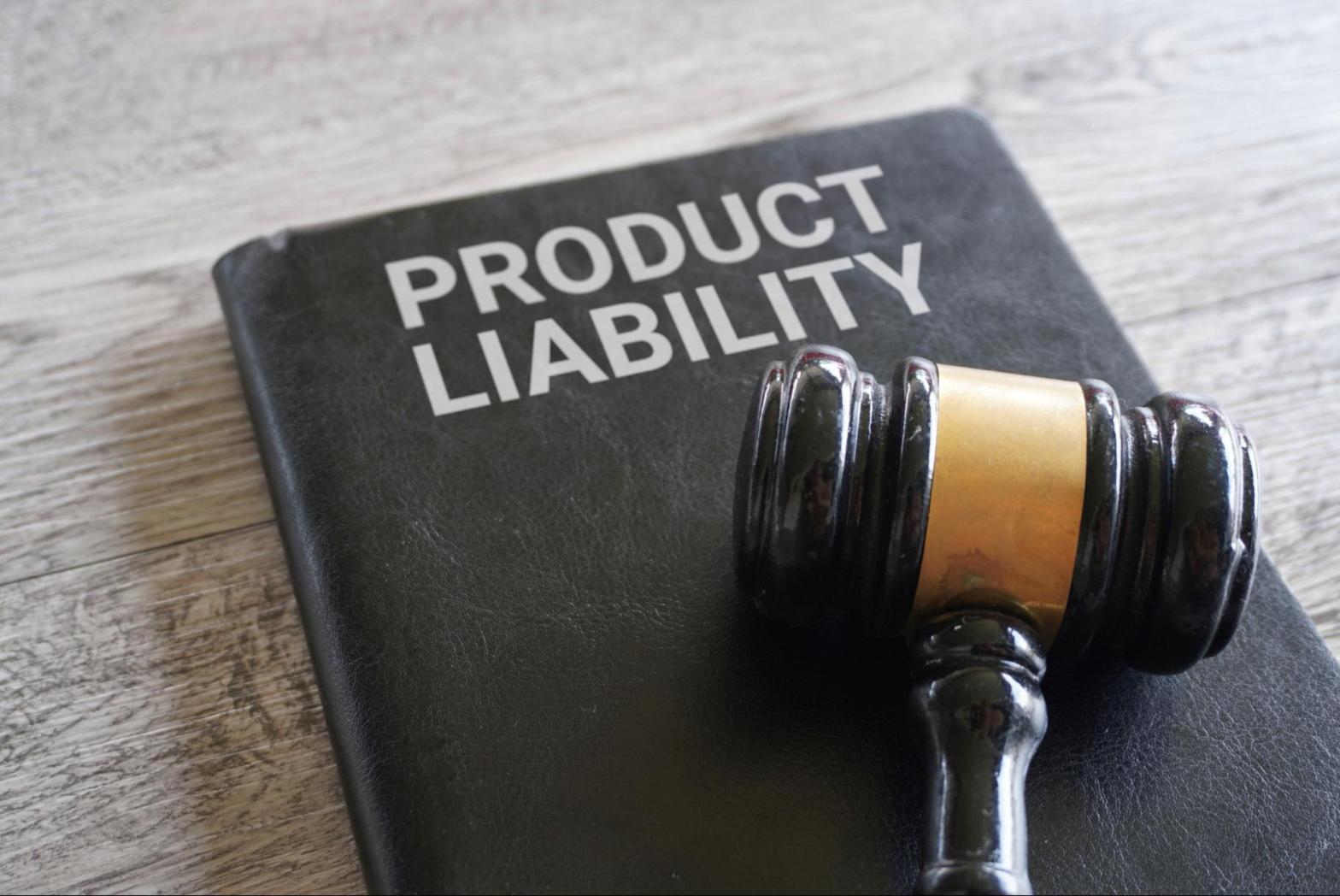 Close-up photo of a wooden gavel resting on a black book titled “Product Liability