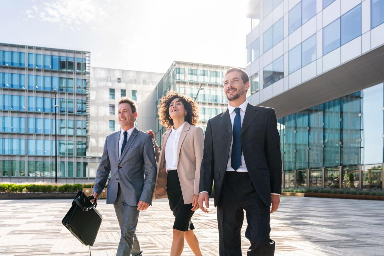 Business professionals evaluating a commercial property while discussing insurance coverage and risk protection