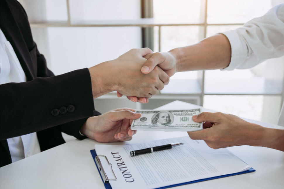 Business owner signing a contract with an insurance agent, exchanging cash while purchasing a surety bond.