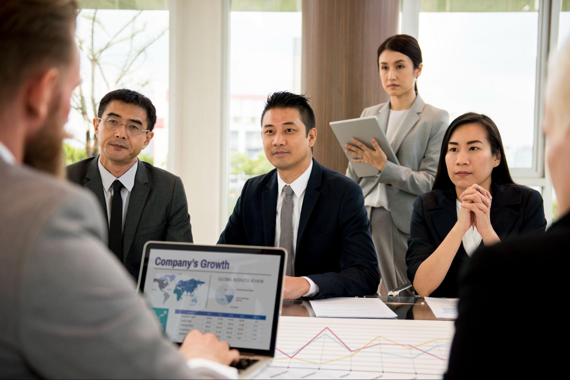 Insurance professional discussing management liability insurance coverage with business owners