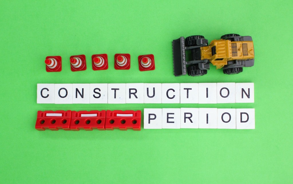 Construction period blocks and a mini excavator illustrating builder's risk insurance during building projects
