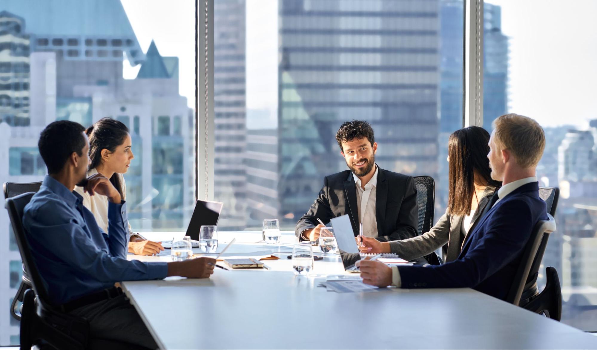 Insurance agent discussing management liability insurance with business owners and executives