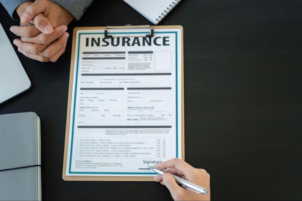 Overhead view of a contractor completing an inland marine insurance form for business equipment coverage