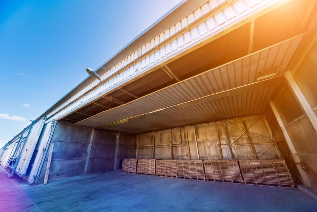 Large industrial warehouse with stored pallets, illustrating inland marine insurance protection for goods in temporary storage